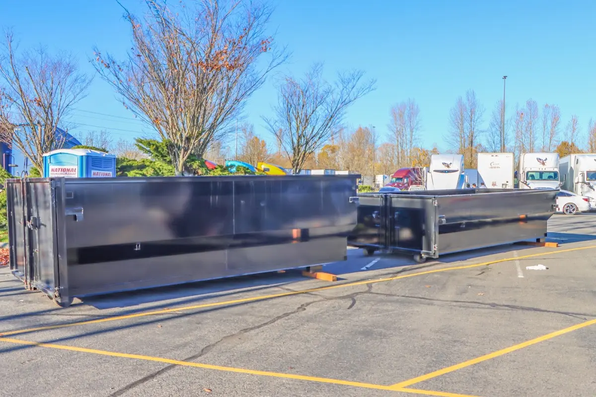 Professional dumpster rental service with roll-off container on residential driveway in Holmdel